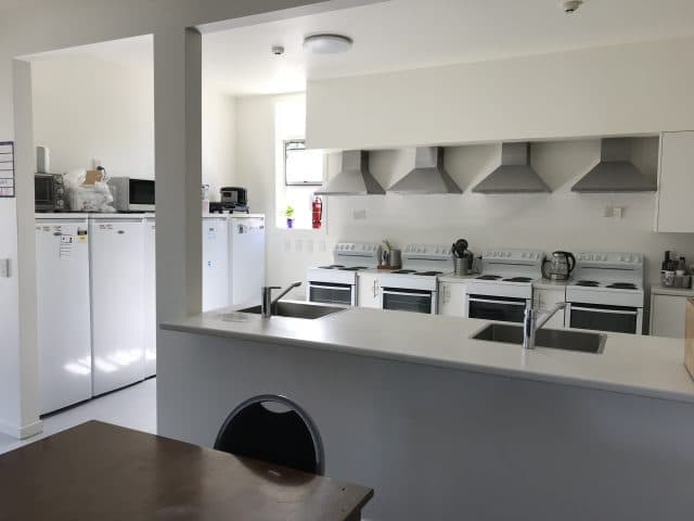 Kitchen with 4 stoves and 3 fridges Nelson Accommodation Modern Clean kitchen